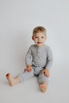 Stylish and functional, our ribbed organic cotton long-sleeve onesie features leg snaps and buttons for easy changes.