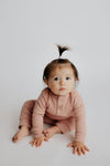 Luxuriously soft ribbed long-sleeve onesie with leg snaps, perfect for lounging and exploring in organic cotton.